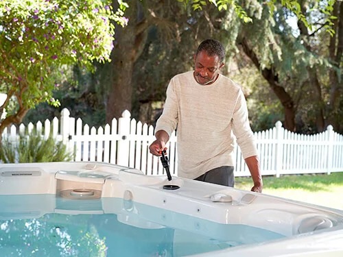 Caldera Spas Paradise Series Reunion Model Arctic White Ash Lifestyle Couple Water Care Moblie - Calderaspas