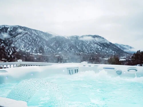 Caldera Spas Utopia Series Cantabria Model Artic White Slate Lifestyle Cover On Snow Mobile - Calderaspas